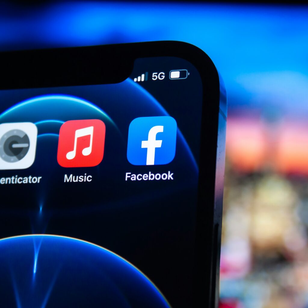 Hands holding smartphone displaying social media app with content planner.