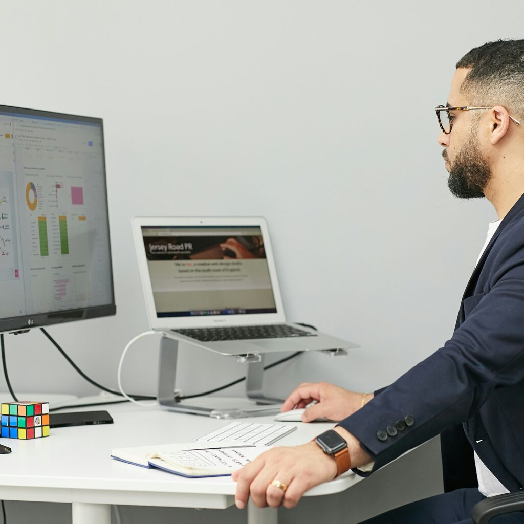 Entrepreneur using AI tools on a laptop to manage business tasks.